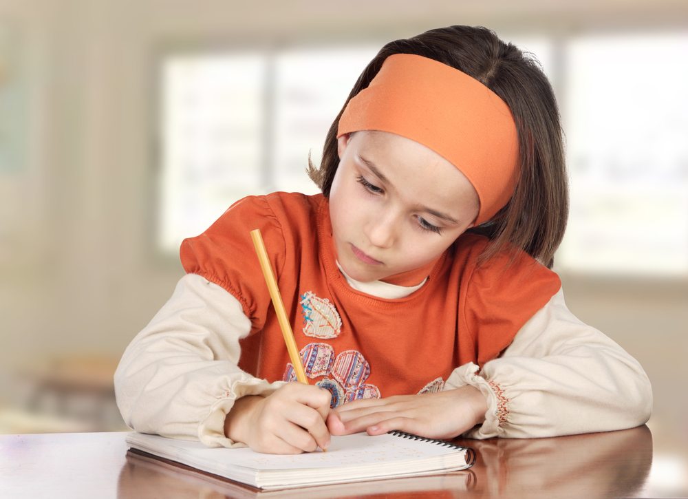 Adorable girl doing her homework